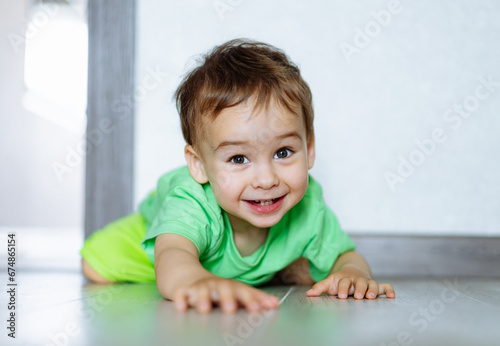 The Joyful Little Boy. A little boy laying on the floor with a smile on his face