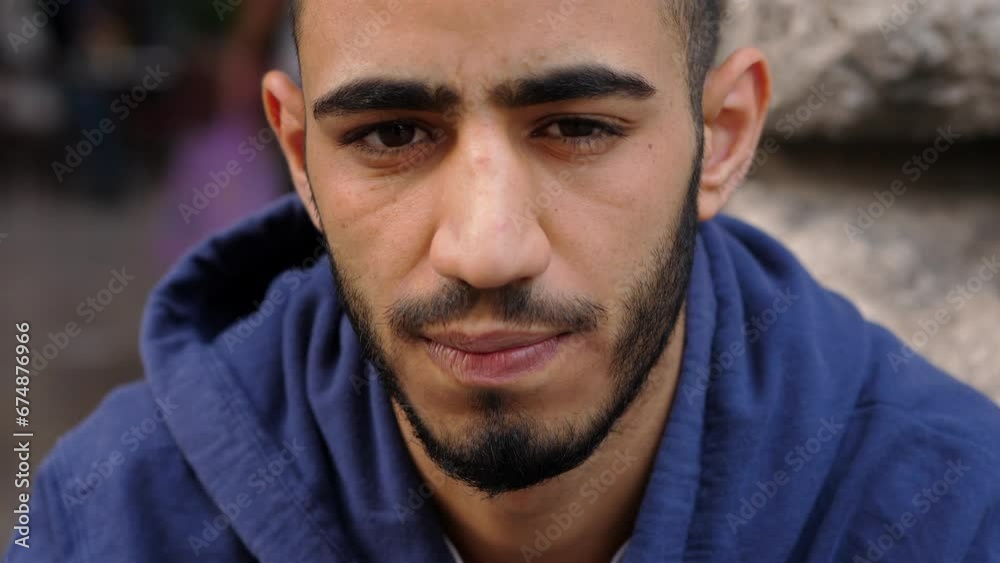 close up on depressed african man's face sitting on the ground staring into space thinking close up on depressed african man's face sitting on the ground staring into space thinking