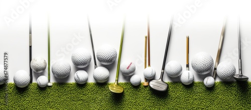 Golf balls and golf clubs on green grass.Golf equipment in the top view.Sports that people around the world play during the holidays for health photo