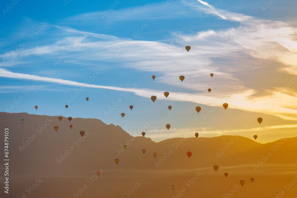 Hot Airl Balloons at Sunrise over Albuquerque and Sandia Mountains, New Mexico	
