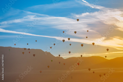 Hot Airl Balloons at Sunrise over Albuquerque and Sandia Mountains, New Mexico 