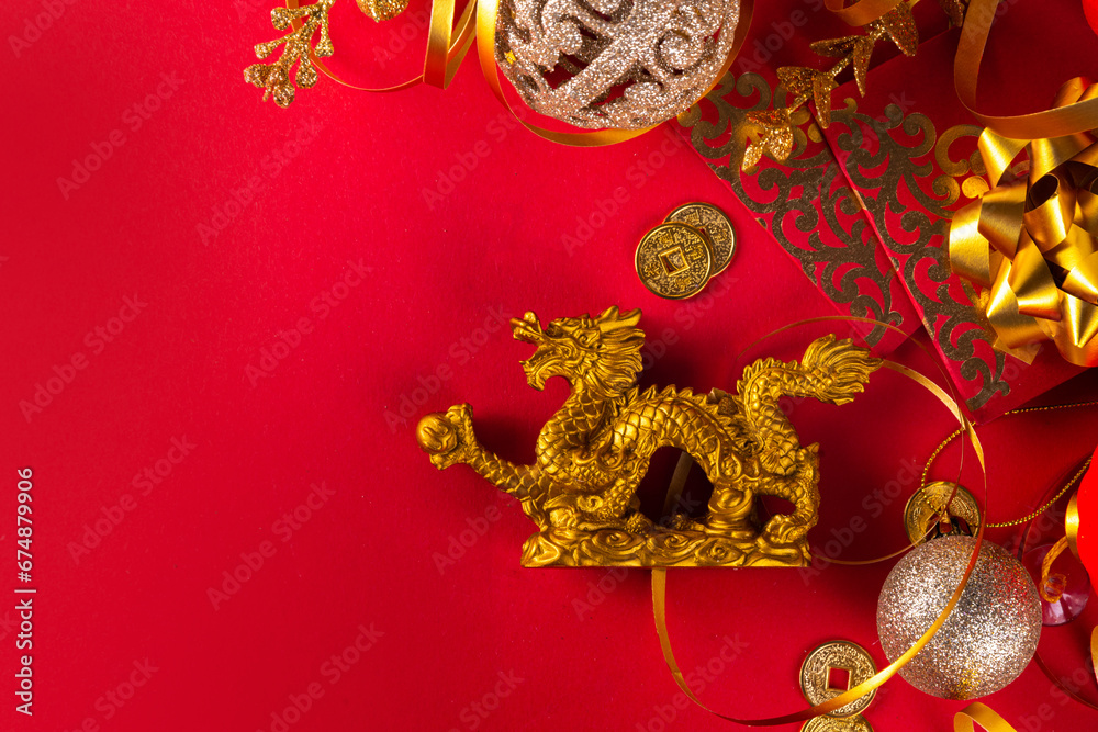 Chinese New Year 2024 greeting card. Bright red asian year of the dragon background with golden dragon figurine, Chinese lanterns, traditional jewelry, gifts, coins, cookies with wishes, copy space