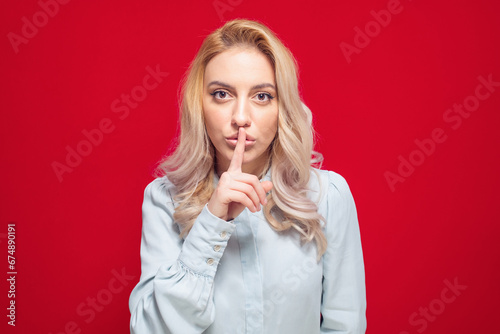 Hush. Woman holding finger on lips, keep the secret concept, isolated on white background