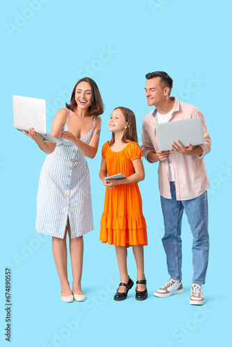 Happy family with gadgets o...