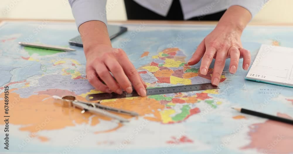 Female hands with ruler and compass on world map Female hands with ruler and compass on world map