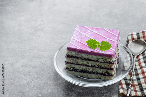 Layred berry cake with blueberry jam on glass plate photo