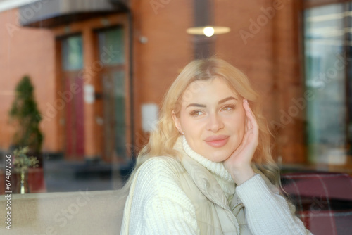 Portrait of a young beautiful blonde with long hair