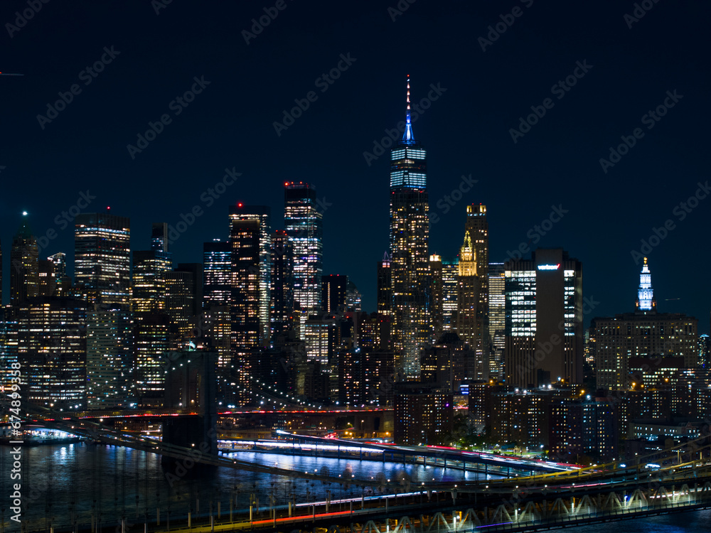 Fototapeta premium New York bridge near me. Aerial night drone photo with city lights and river