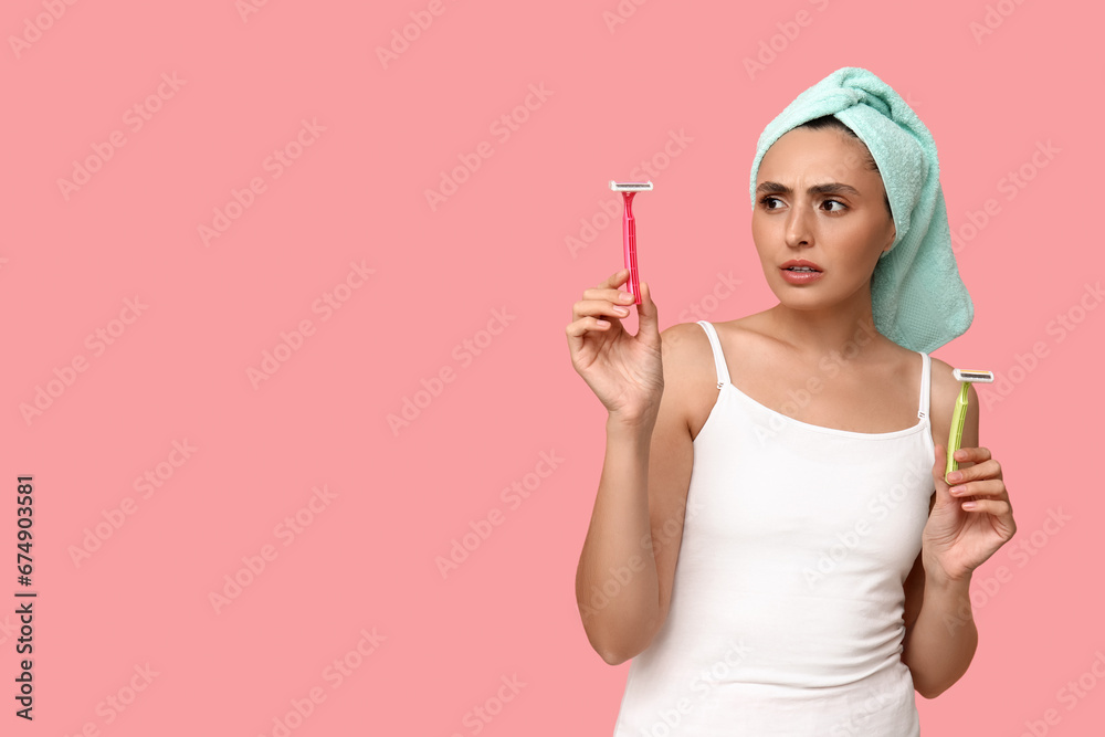 Worried young woman with razors on pink background Worried young woman with razors on pink background