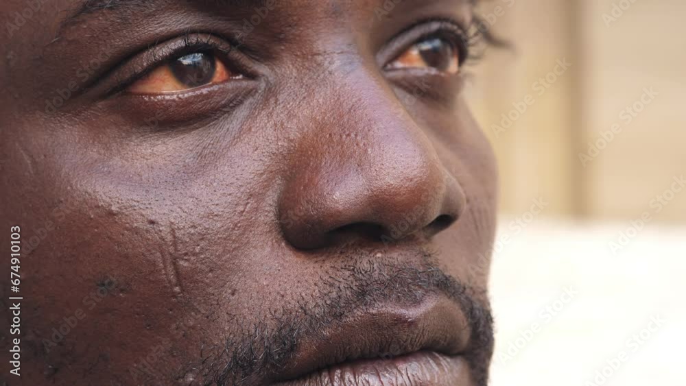 close up portrait of unhappy young african man opening his eyes looking ahead close up portrait of unhappy young african man opening his eyes looking ahead