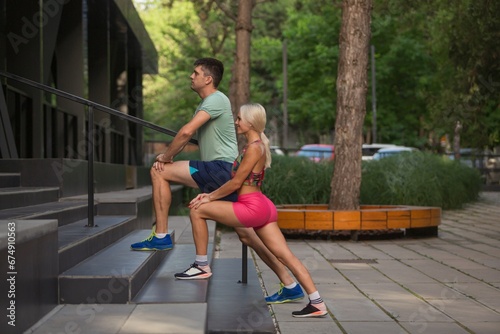 Happy young couple training cardio workout in the park