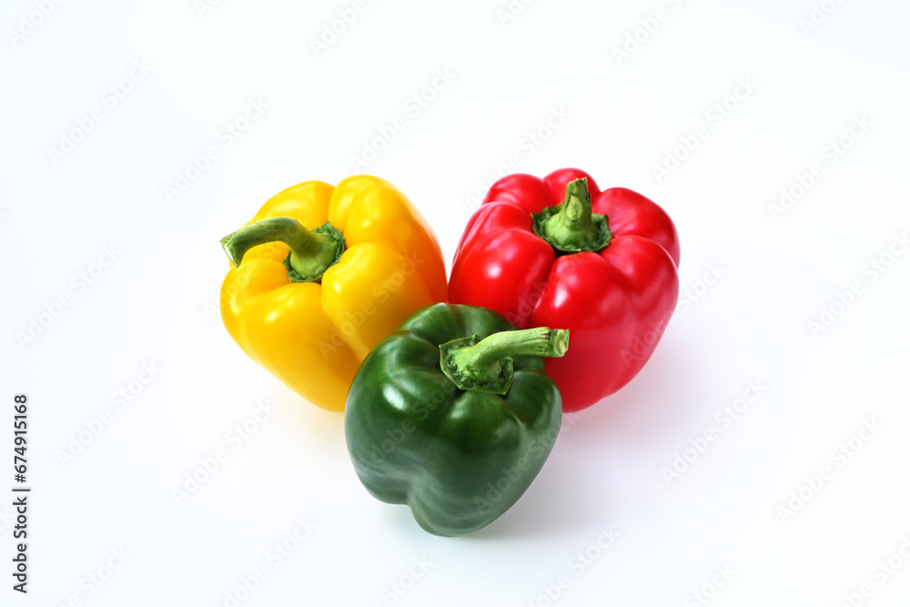 three sweet peppers red, yellow and green on a white background three sweet peppers red, yellow and green on a white background