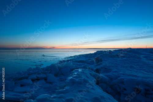 The frozen shores of Gulf of Bothnia in winter in Finland with packed ice in the foreground
