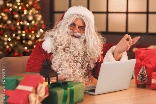 Santa claus using a laptop ...