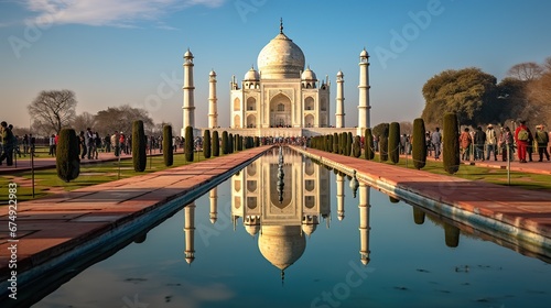 AGRA, INDIA - MARCH 5 2018: Tourists sighteseeing, exploring and admiring famous the Taj Mahal photo