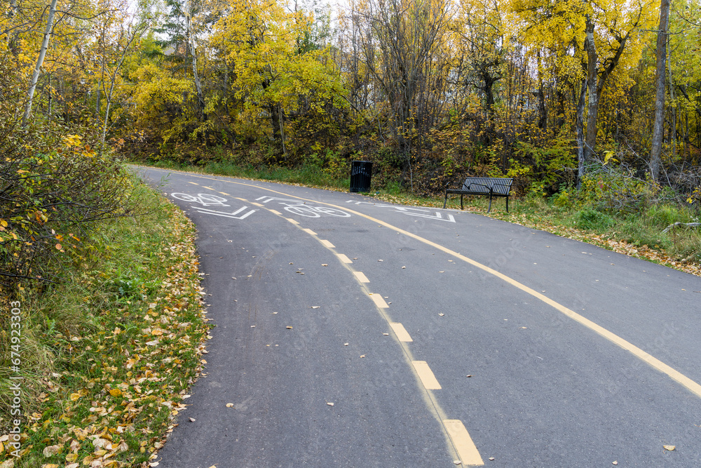 Shared-use path for cyclists and pedestrians in fall season Shared-use path for cyclists and pedestrians in fall season