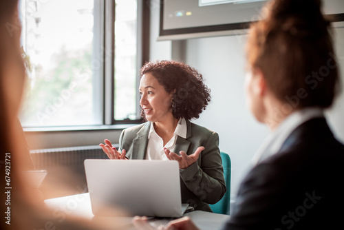 Businesswoman giving presentation in conference room