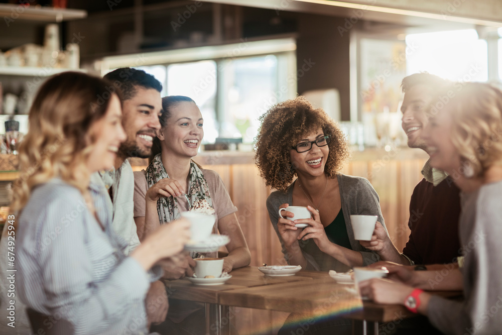 Group of happy friends having coffee in cafe