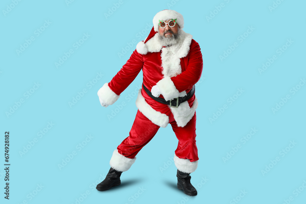 Funny Santa Claus dancing on blue background Funny Santa Claus dancing on blue background