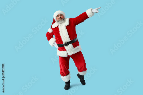 Dancing Santa Claus on blue background