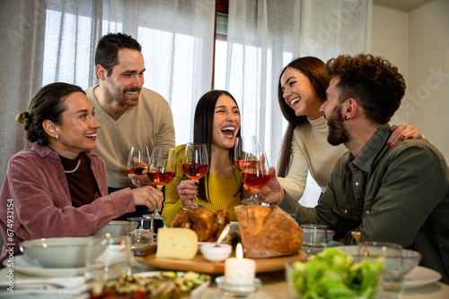 Happy people having fun eating and drinking together - Family having dinner toasting wine glasses at home - Food and beverage concept - Focus mid woman