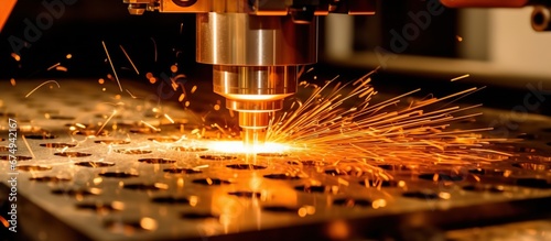 CNC Laser cutting of metal, modern industrial technology Making Industrial Details. The laser optics and CNC (computer numerical control) are used to direct the material or the laser beam generated.