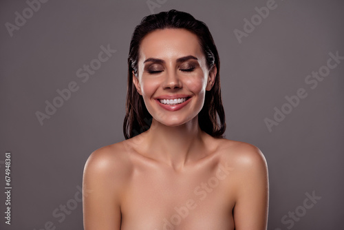 Photo portrait of lovely young lady laugh smile enjoy douche spa salon isolated on dark gray color background