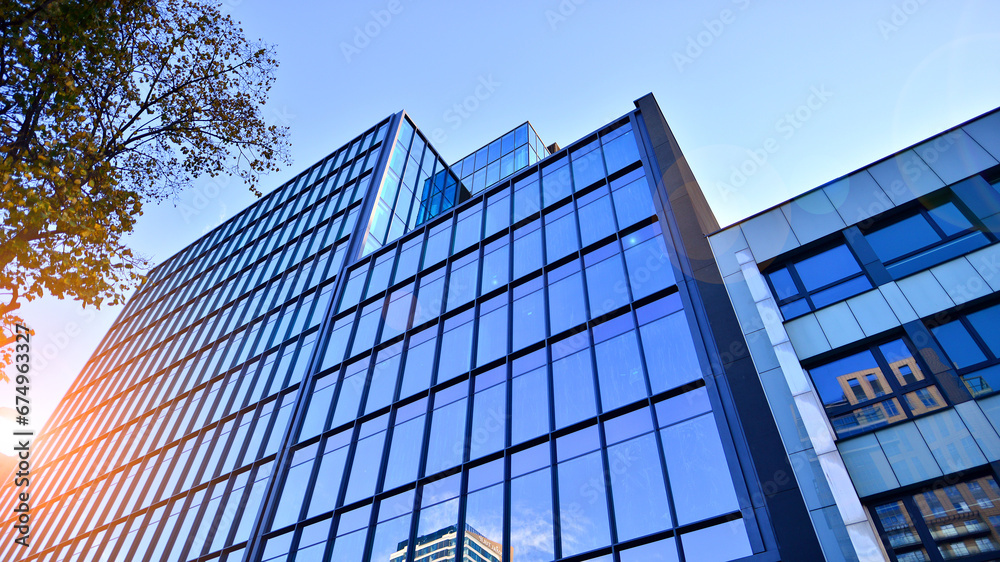 Looking up blue modern office building. The glass windows of building with aluminum framework. Looking up blue modern office building. The glass windows of building with aluminum framework.