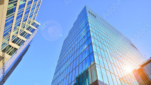 Looking up blue modern office building. The glass windows of building with  aluminum framework. photo