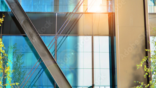 Steel and glass. The subject of modern architecture or construction industry. Modern office building facade with tall steel construction elements and full height windows between. 
