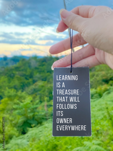 Inspirational life quote concept with blurred nature background - Learning is a treasure that will follow its owner everywhere

 photo