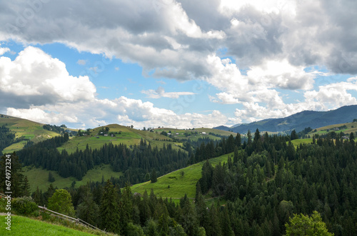 Mountain slopes, trees and clouds in the sky. Amazing landscape view of Ukrainian Carpathian mountains © Dmytro