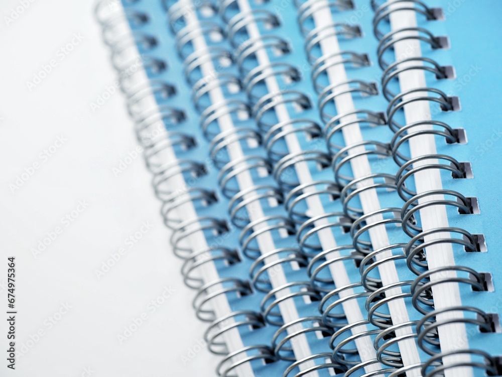 Five spiral notebooks with blue covers on a white background Five spiral notebooks with blue covers on a white background