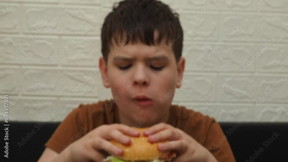 Child, hands and eating burger on table for delicious lunch, meal or food with healthy vegetables at home. Hand of hungry little boy holding beef hamburger for fresh dinner, nutrition or vitamins Child, hands and eating burger on table for delicious lunch, meal or food with healthy vegetables at home. Hand of hungry little boy holding beef hamburger for fresh dinner, nutrition or vitamins
