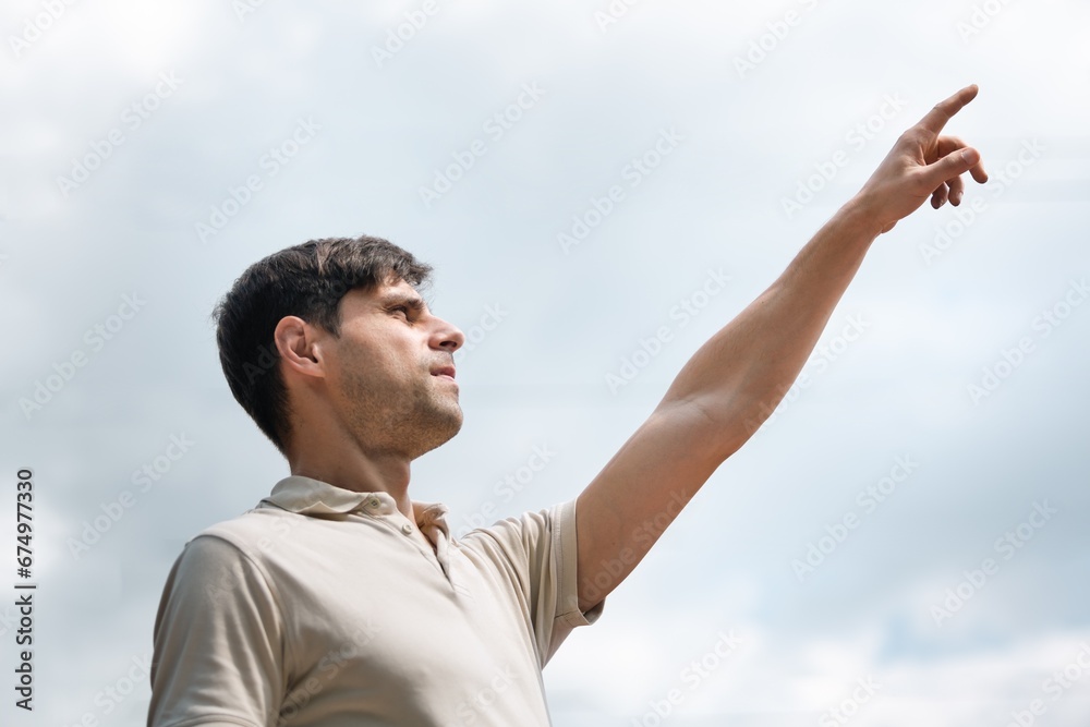 Positive young man having idea and pointing finger Positive young man having idea and pointing finger