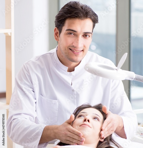 Young woman visiting male doctor cosmetologist