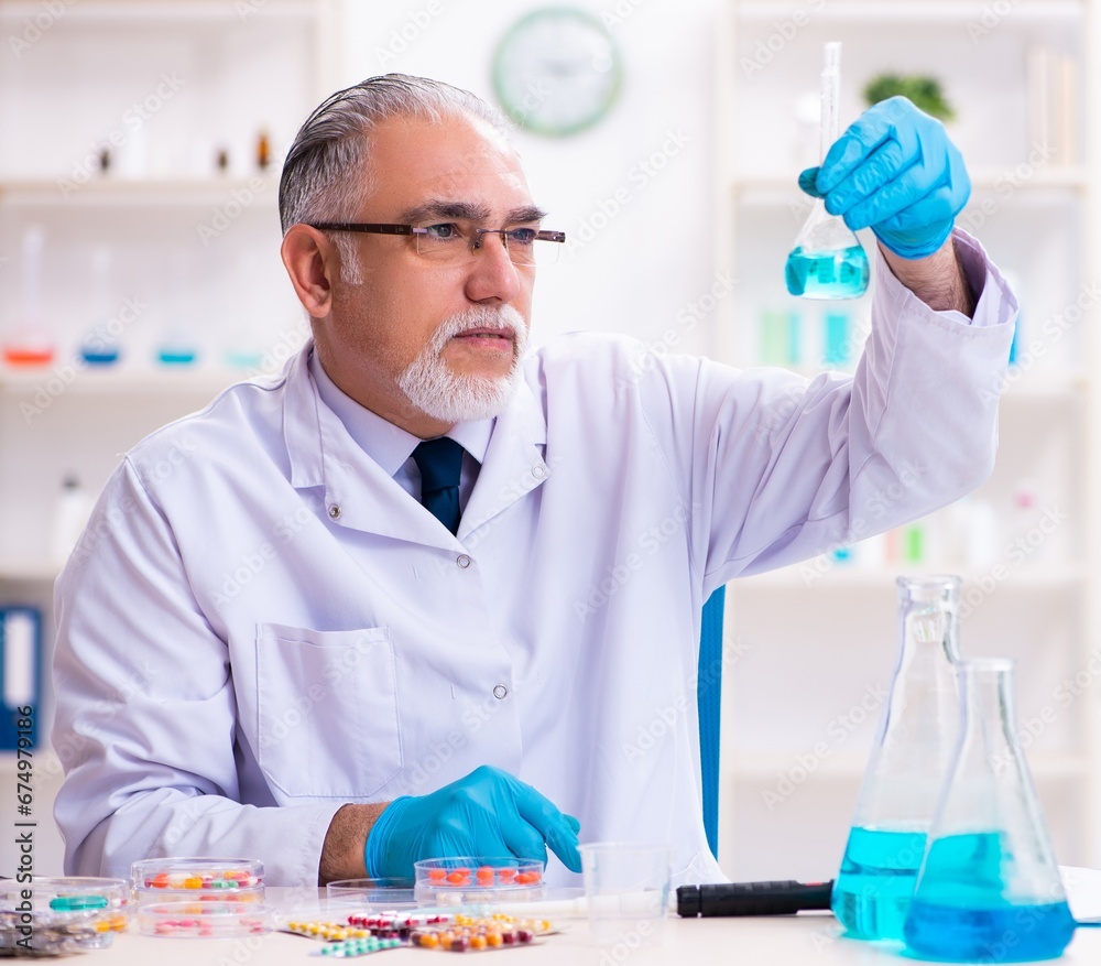 Old male chemist working in the lab Old male chemist working in the lab