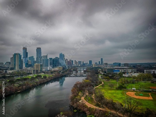 the city skyline is seen in the distance while a river winds through