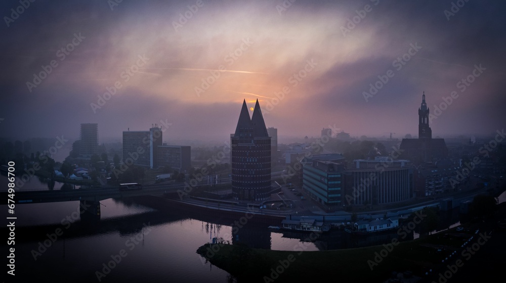 Aerial view of Roermond cityscape at foggy sunset in Netherlands