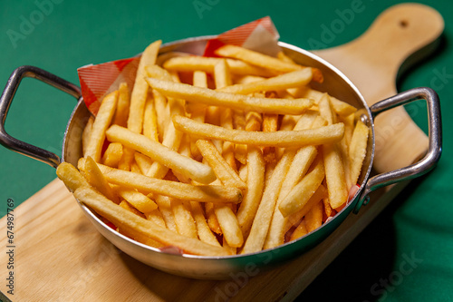 French fries dish top view close up green background