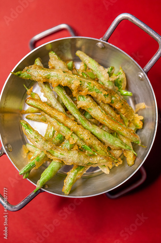 Fried tempura pod dish top view close up red background