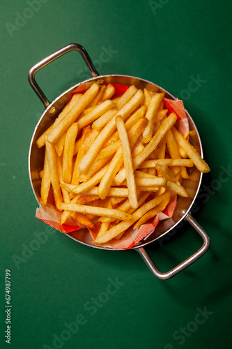 French fries dish top view close up green background