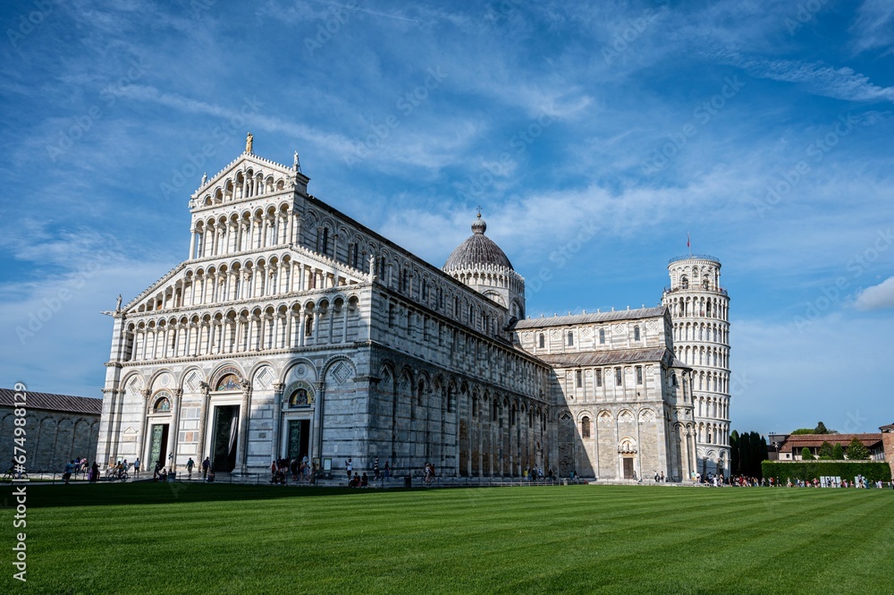 Cathedral and the Pisa Leaning Tower in the famous Pisa's Cathedral Square in Italy.