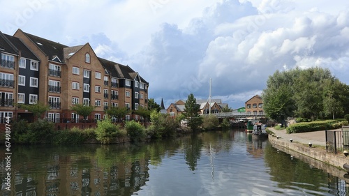 Peaceful residential area, with a paved path running alongside a tranquil canal in Apsley