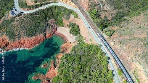 Drone footage of cars on a road over rocky valley by the sea in  Le Trayas, Saint Raphael, France photo