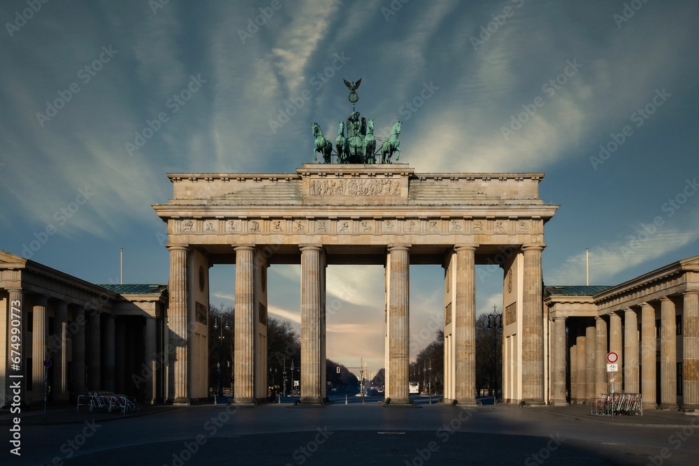 Obraz premium Historic Brandenburg Tor under a dramatic blue sky