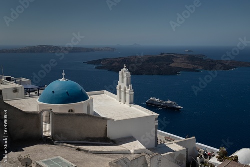 Beautiful blue domed church over the water in Santorini, Greece