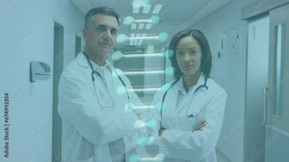 Animation of dna structure spinning over diverse male and female doctors standing at hospital Animation of dna structure spinning over diverse male and female doctors standing at hospital
