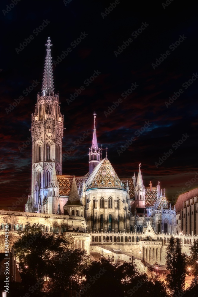Fototapeta premium Illuminated Matthias Church at night illuminated against a dark sky background