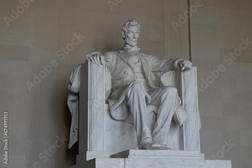 Majestic stone statue of a figure resembling 16th President of the United States, Abraham Lincoln photo